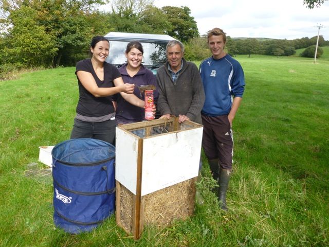 From Left to Right - Rebecca Northey (Derek Gow Consultancy), Chloe Wonnacott (Derek Gow Consultancy), Dennis Vanstone (Westland Countryside Stewards) and Shaun Thomas (Westland Countryside Stewards). They are standing around a water vole release cage and Rebecca is holding a water vole.
